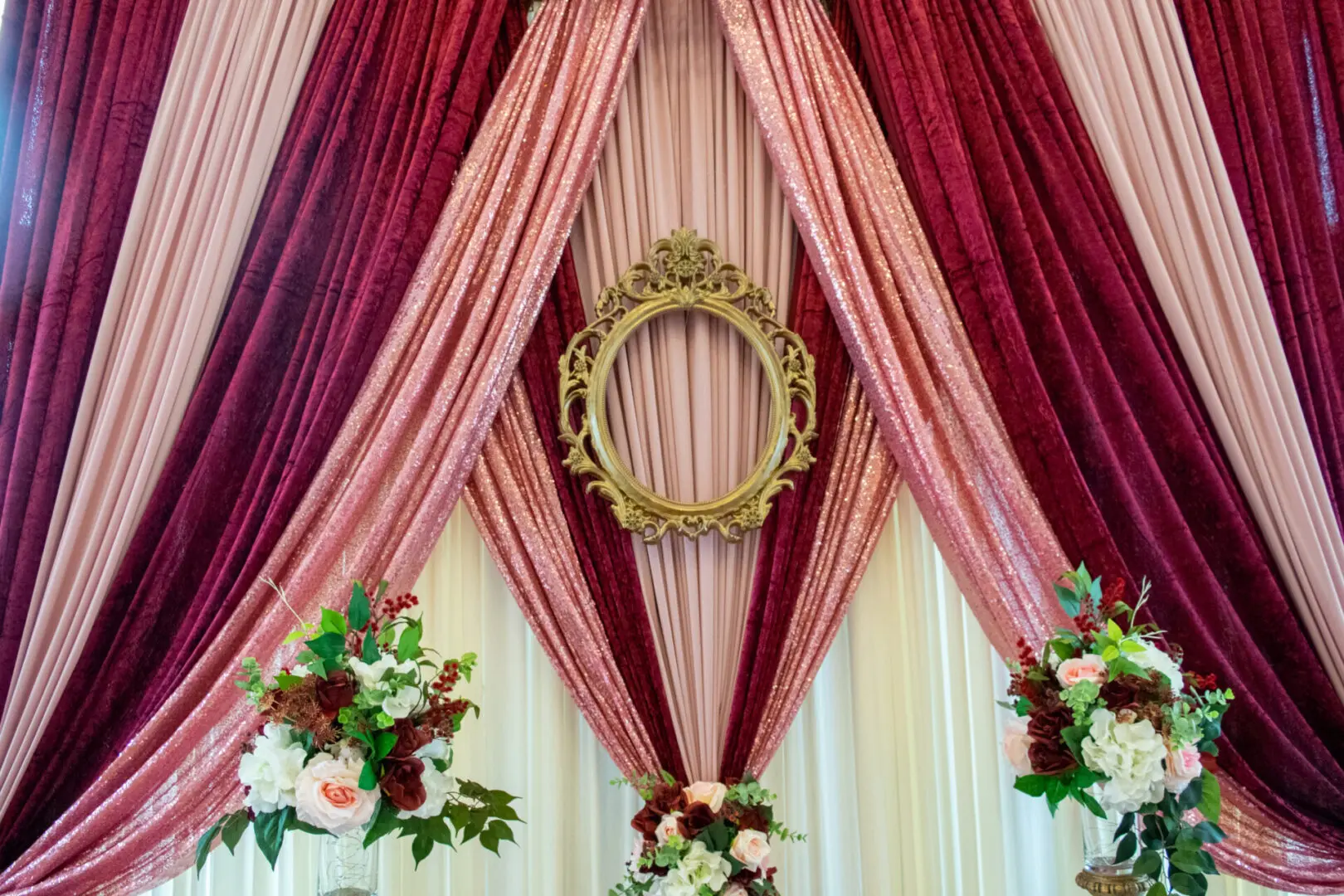 Elegant draped curtains with floral arrangements.