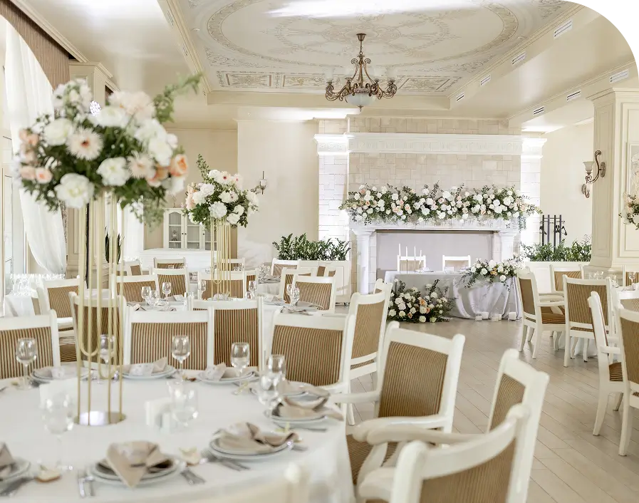Elegant wedding reception venue with floral decorations.